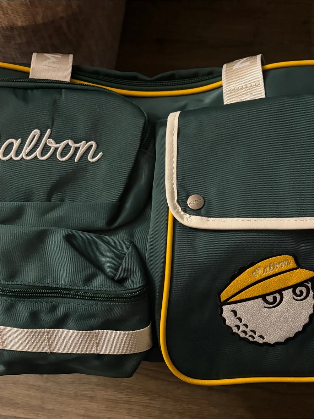 MALBON Green and gold duffel/weekender travel bag.